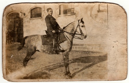 THE CZECHOSLOVAK REPUBLIC - CIRCA 1920s: Vintage photo shows a young soldier (hussar) sits on the horse. Retro black & white photography.のeditorial素材