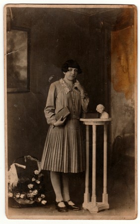 GERMANY - CIRCA 1930s: Vintage photo shows woman in a photography studio. Retro black & white studio photography with sepia effect.のeditorial素材
