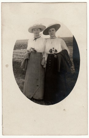 GERMANY - SEPTEMBER 24, 1916: Vintage photo shows young ladies wear  period clothes. Photo is oval shaped. Retro black & white photography.のeditorial素材