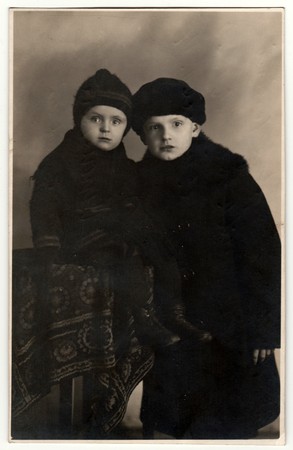 THE CZECHOSLOVAK REPUBLIC - DECEMBER 23, 1922: Vintage photo shows two small boys (2 and 8 years old). Retro black & white photography.のeditorial素材