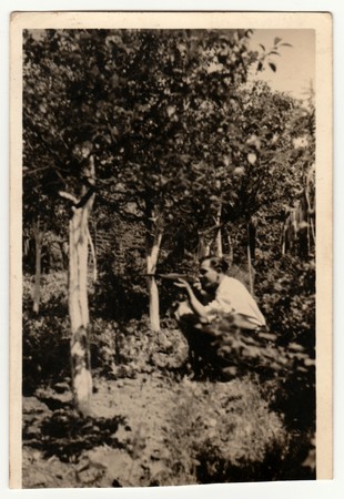 THE CZECHOSLOVAK REPUBLIC - MAY 1946: Vintage photo shows man holds rifle. Retro black & white...
