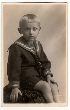 PRAHA (PRAGUE) THE CZECHOSLOVAK REPUBLIC - CIRCA 1946: Vintage photo shows  a young boy wears sailor costume. Retro black & white photography.のeditorial素材