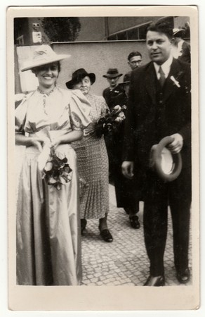 PRAHA (PRAGUE), THE CZECHOSLOVAK REPUBLIC - JUNE 27, 1939: Vintage photo shows newlyweds go from wedding ceremony. Retro black & white studio photography.のeditorial素材