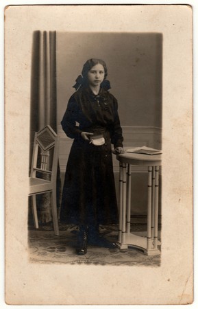 THE CZECHOSLOVAK REPUBLIC - CIRCA 1920s: Vintage photo shows young girl poses in a photography...