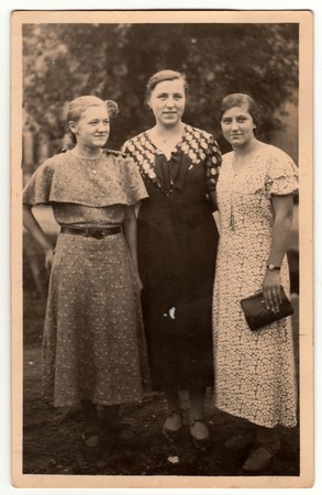 THE CZECHOSLOVAK REPUBLIC -  CIRCA 1940s: Vintage photo shows three mature woman poses outdoors. Retro black & white photography.のeditorial素材