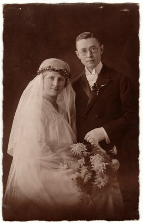 PRAHA (PRAGUE), THE CZECHOSLOVAK REPUBLIC - CIRCA 1930s: Vintage photo shows newlyweds. Groom wears glasses and bride wears long veil. Retro black & white wedding photography.のeditorial素材