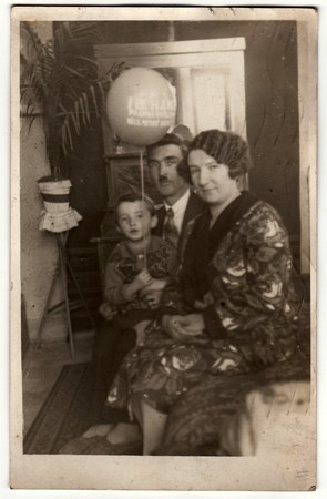 PRAHA (PRAGUE), THE CZECHOSLOVAK REPUBLIC - MARCH 15, 1931: Vintage photo shows family in the living...
