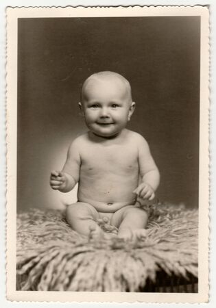 THE CZECHOSLOVAK SOCIALIST REPUBLIC - CIRCA 1960s: Vintage photo shows a cute naked baby boy. Retro black & white  photography.のeditorial素材