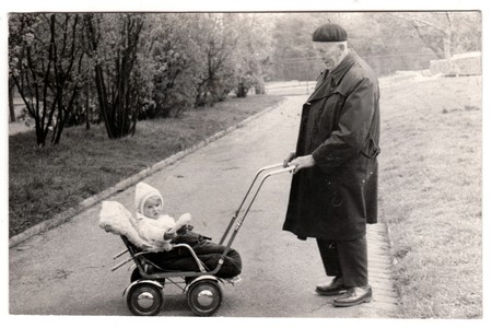 THE CZECHOSLOVAK SOCIALIST REPUBLIC - CIRCA 1950s: Vintage photo shows grandfather with a small baby in the pram (carriage). Retro black & white  photographyのeditorial素材