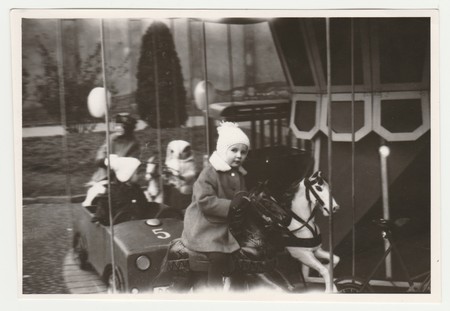 THE CZECHOSLOVAK SOCIALIST REPUBLIC - CIRCA 1970s: Vintage photo shows children at the amusement park. Children and merry-go-round. Retro black & white  photography.のeditorial素材