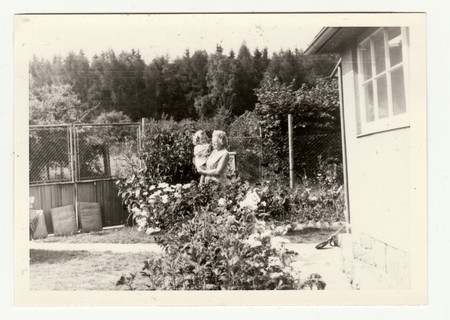 THE CZECHOSLOVAK SOCIALIST REPUBLIC - CIRCA 1970s: Vintage photo shows grandmother cradles a small girl in the garden. Retro black & white  photography.のeditorial素材
