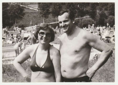 THE CZECHOSLOVAK SOCIALIST REPUBLIC - CIRCA 1980s: Vintage photo shows a mature couple next to outdoor swimming pool. Holidays (vacation) theme. Retro black & white  photography.のeditorial素材