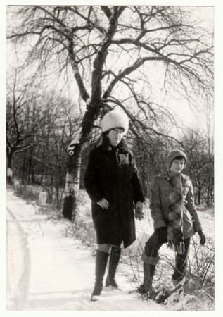 THE CZECHOSLOVAK  SOCIALIST  REPUBLIC - 1976: Vintage photo shows mother and daughter in the winter time. Retro black & white  photography.のeditorial素材