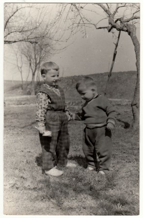THE CZECHOSLOVAK SOCIALIST REPUBLIC - CIRCA 1960s: Vintage photo shows two  small boys play outdoors. Funny and cute photo. Retro black & white  photographyのeditorial素材