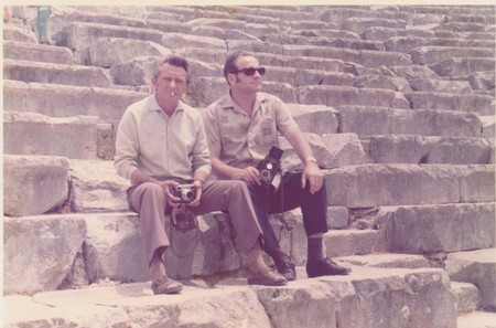 GREECE - CIRCA 1980s: Vintage photo shows two men sit on ancient steps. Men hold cameras. Holidays (vacation) theme. Black & white retro photography.のeditorial素材