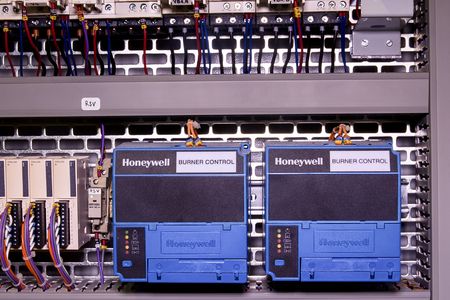 Image shows control cubicle. Honeywell electric device - burner control inside power case.