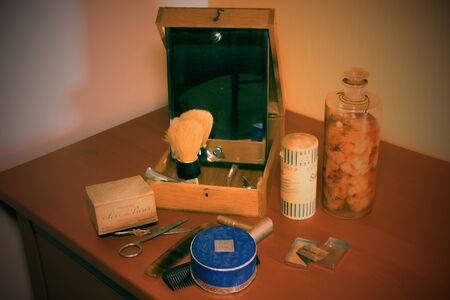 Vintage shaving accessories, perfumes and face powder. Close-up. Add retro effect.のeditorial素材