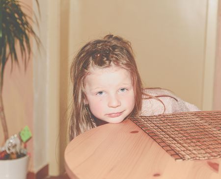 Bored girl. 5 years old. Portrait of blond small girl. Add haze effect.の写真素材