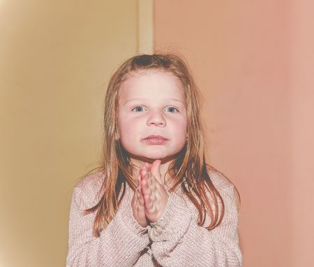 Girl is clapping. 5 years old. Funny and children concept. Add haze effect.