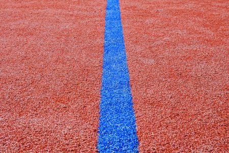 Blue line on red playing field. Copy space. Sport texture and backgroundの写真素材