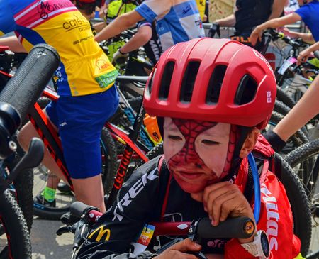 Traditional bike competition Bicycle for life . Racers waiting to start. Young cyclist has make-up like Spiderman .のeditorial素材
