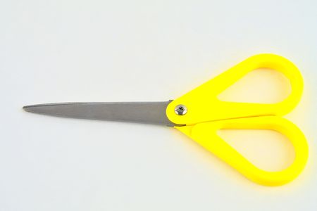 Yellow scissors isolated on a white background. Top viewの写真素材