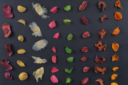 Dry aromatic potpourri leaves close-up. Background of colored aromatic potpourri leaves. Geometric...