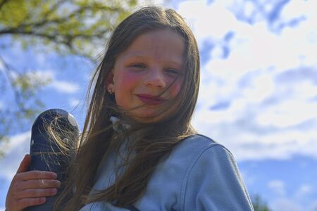 Portrait of happy smiling child girl on playground in Summer.