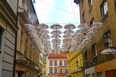 Umbrellas above the street in Bratislavas Old Town district. Umbrellas hang in rows on the street as a decoration.のeditorial素材