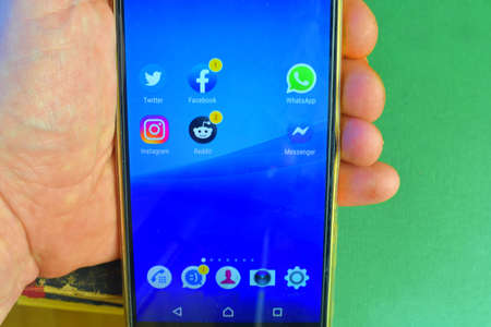 Social apps icons on mobile phone Sony. Different kinds of apps on a mobile phone display. Instagram, Twitter, Facebook, Reditt, WhatsApp etc.のeditorial素材