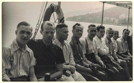 Vintage photo shows group of men pose on ship during a cruise. Antique black and white portrait. Circa 1920sのeditorial素材