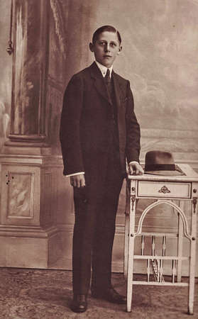 GERMANY - CIRCA 1920s: Vintage photo shows an elegant boy wears black suit. Black and white antique...