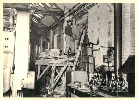 FRAUREUTH, EAST GERMANY - MARCH 3, 1965: The retro photo shows bricklayer working. Authentic photo...