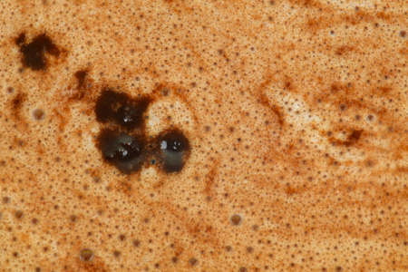 Macro shot of a cup of coffee with cream. Close-up of coffee with milk. Cappuccino or latte texture with foamy, close-up top view macroの写真素材