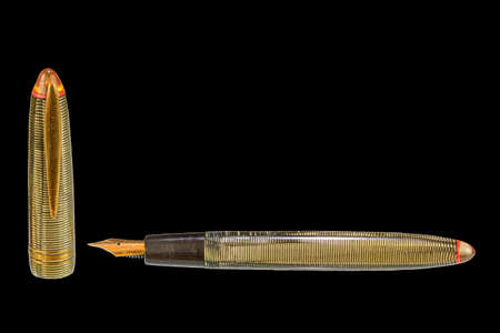 Old fountain pen on a black background with clipping path. Big copy space. Vintage fountain pen...