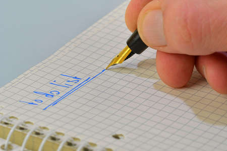 Man hand writing text to do list in notebook. Copy space. Concept of duties, resolutions