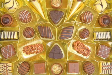 Different chocolate pralines. Box of belgian pralines of different shapes. Assortment of fine...