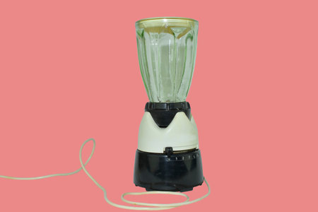Retro electric blender isolated on very soft red background. Vintage blender from the late 1960sの写真素材