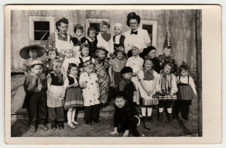 PRAGUE, THE CZECHOSLOVAK REPUBLIC - CIRCA 1950s: Vintage photo shows children - pupils wear funny costumes. Children pose after theater performance. Black and white photographyのeditorial素材
