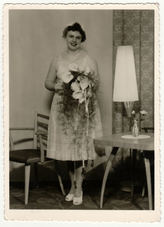 THE CZECHOSLOVAK SOCIALIST REPUBLIC - CIRCA 1960s: Vintage photo shows a bride. Bride wears a soft veil and holds calla flowers - bouquet. Retro black and white photography. Circa 1960.のeditorial素材
