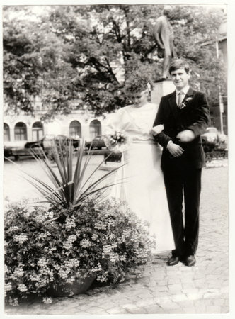 THE CZECHOSLOVAK SOCIALIST REPUBLIC - CIRCA 1980s: Vintage photo shows a bride with bridegroom. Bride holds wedding flowers - bouquet. Retro black and white photography. Circa 1980.のeditorial素材