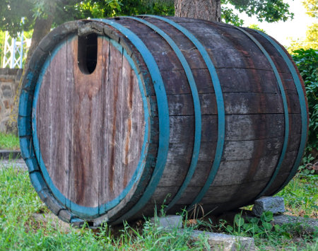 Retro concept of winemaking and the good old days. An old wine barrel in front of the wine cellar. The concept of winemaking and organic winemaking. Sustainable winery conceptの写真素材