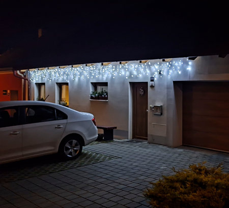 Festive Christmas lFestive Christmas lighting of the house. Holiday Christmas lights on the house in winter. House illumination during Christmas and New Yearの写真素材