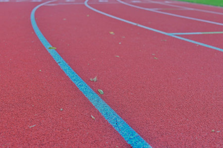 View of an athletic track. Tartan surface on an athletic field with lanes. Concept of sports,...