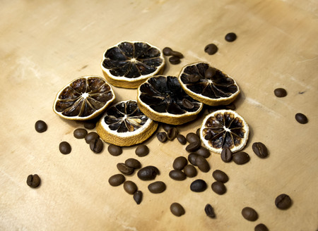 Ingredients of natural cosmetics on a wooden background. Dried citrus and coffee beans. Eco products.の写真素材
