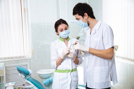 Two dentists portrait man and woman in dental office. Concept healthyの写真素材