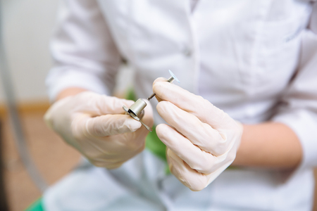 Dentist doctor hand holding medical tools in dental office. Concept healthyの写真素材