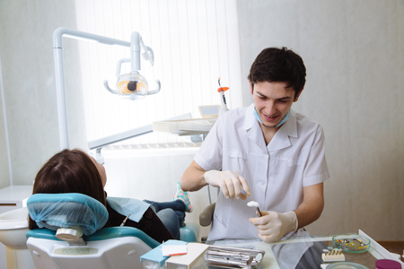 Professional dentist doing teeth checkup on female patient dental surgery. Concept healthyの写真素材