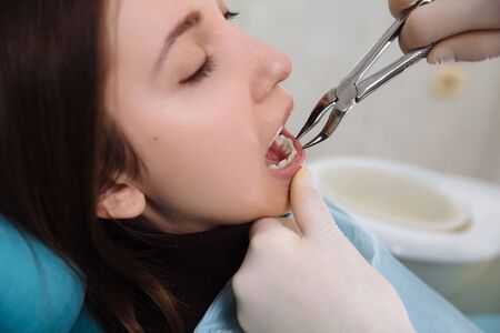 Female patient with dentist and assistant - dental treatment. Concept healthyの写真素材