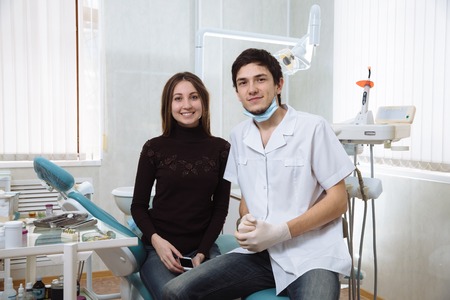 Professional dentist man with his smileing patient woman. Concept healthyの写真素材